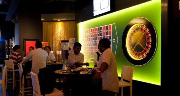 People spend leisure time in a restaurant with online roulette